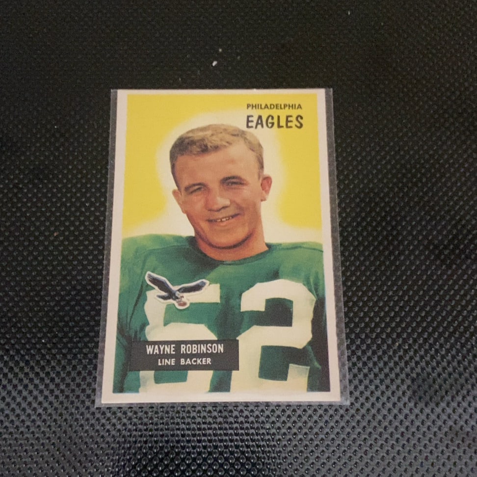 1957 Topps Wayne Robinson Philadelphia Eagles Football Card: This is a 1957 Topps football card featuring Philadelphia Eagles linebacker Wayne Robinson. The card showcases a clean, iconic design with a yellow background and appears to be in excellent