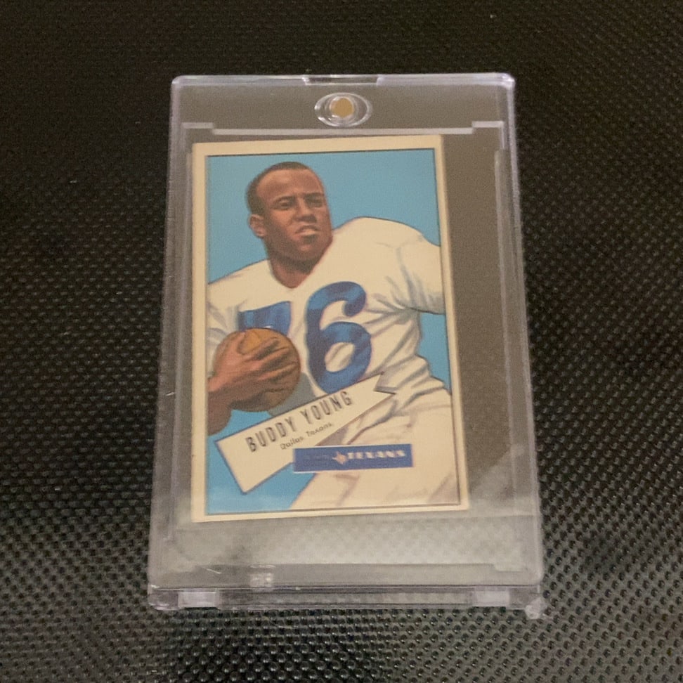 1952 Bowman Buddy Young Dallas Texans Football Card: This is a 1952 Bowman football card featuring Buddy Young of the Dallas Texans. The card is encased in a protective magnetic holder and appears to be in well-preserved vintage condition with vibrant