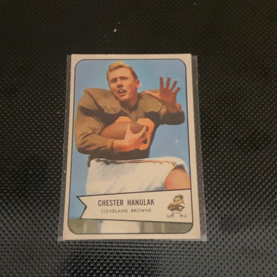 Vintage Chester Hanulak Cleveland Browns Trading Card: This is a 1957 Topps football card featuring Cleveland Browns player Chester Hanulak. The card shows the running back in action and includes a vintage team logo in the corner. It appears to be in