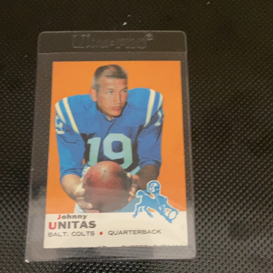 1968 Topps Johnny Unitas Football Card: This is a 1968 Topps Johnny Unitas football card featuring the legendary Baltimore Colts quarterback. The card showcases a classic portrait design with a vibrant orange background, team logo, and the