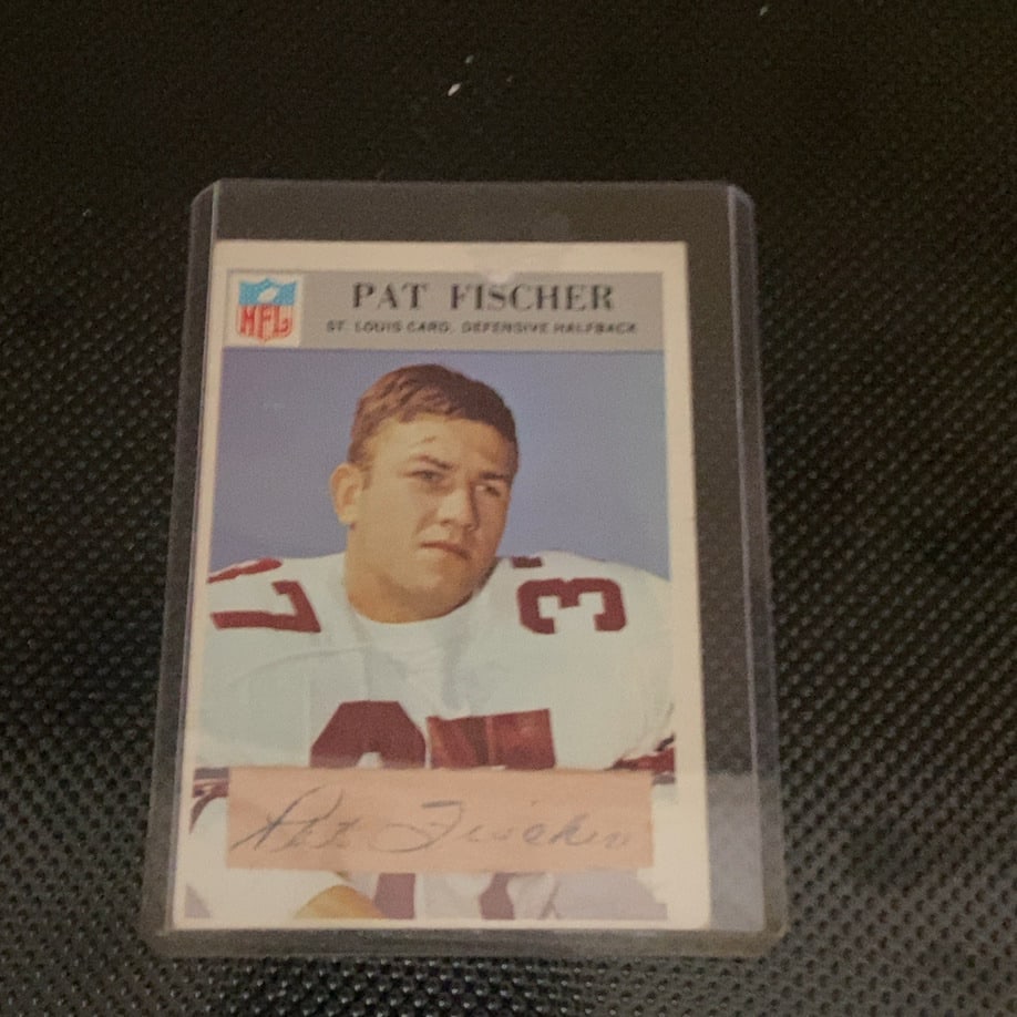 1963 Topps NFL St. Louis Cardinals Pat Fischer Card: This is a 1963 Topps NFL football card featuring St. Louis Cardinals defensive halfback Pat Fischer. The card displays a portrait of the player with his printed autograph on a tab at the bottom. It is