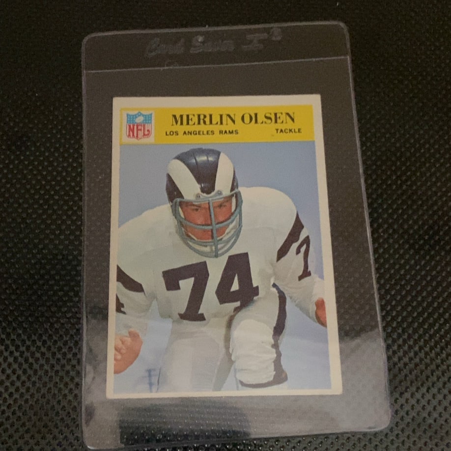 1968 Philadelphia Merlin Olsen Los Angeles Rams Card: This is a 1968 Philadelphia football card featuring NFL Hall of Famer Merlin Olsen of the Los Angeles Rams. The card showcases a classic portrait of the legendary defensive tackle and is preserved in
