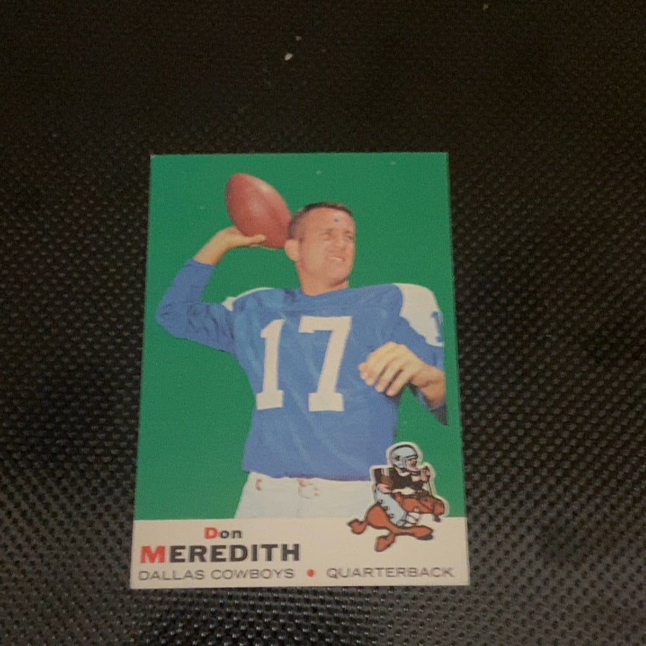 1968 Topps Don Meredith Dallas Cowboys Football Card: This is a 1968 Topps football card featuring legendary Dallas Cowboys quarterback Don Meredith. The card displays a vibrant green background and the iconic Topps team mascot graphic in the lower