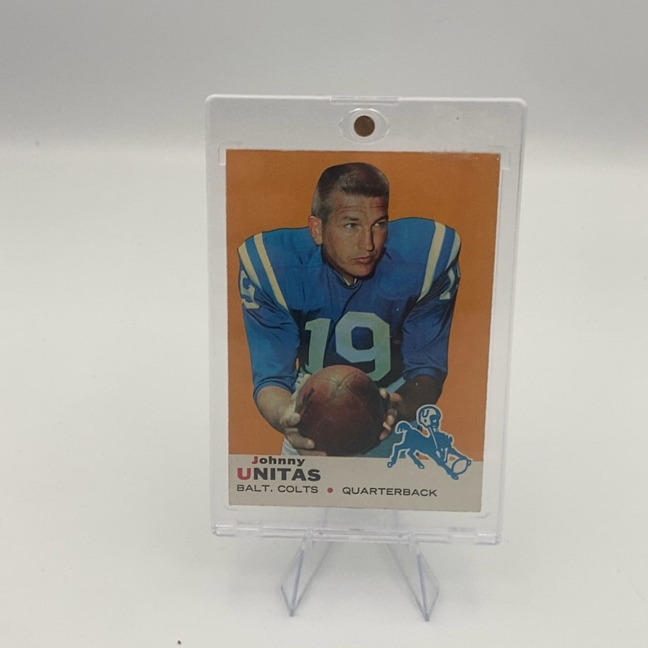 1964 Topps Johnny Unitas Baltimore Colts Football Card: This is a 1964 Topps football card featuring Hall of Fame quarterback Johnny Unitas of the Baltimore Colts. The card is encased in a protective plastic holder and presents an iconic action-posed