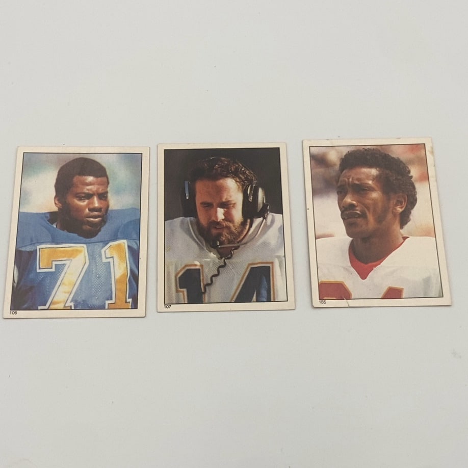 Three Vintage Football Trading Cards: A collection of three vintage football trading cards showing players in uniform. The cards feature individual portraits with jersey numbers 71, 14, and a partially visible number, along with card set