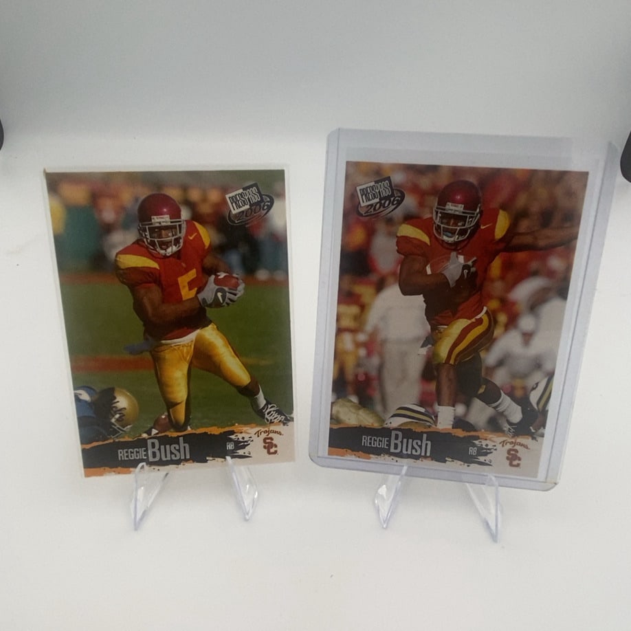 2006 Press Pass Reggie Bush: These are two 2006 Press Pass football trading cards featuring USC running back Reggie Bush. The cards show Bush in his collegiate Trojans uniform, with the Press Pass 2006 logo prominently displayed