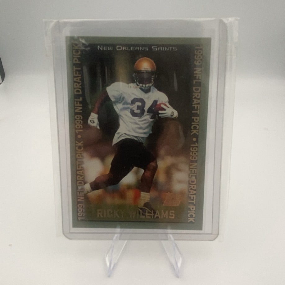 1999 Topps Ricky Williams: This is a 1999 Topps trading card featuring Ricky Williams. The card is labeled as a 1999 NFL Draft Pick and includes the New Orleans Saints team designation. It is encapsulated in a protective