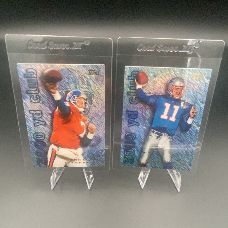 Topps 3000 Yd Club John Elway and Drew Bledsoe: Two Topps 3000 Yard Club trading cards featuring football players John Elway of the Denver Broncos and Drew Bledsoe of the New England Patriots. Both cards are housed in protective plastic sleeves and
