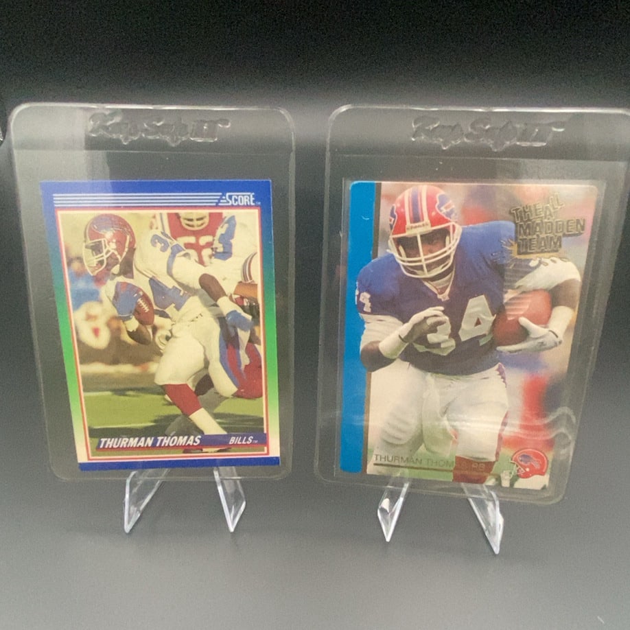 Thurman Thomas Score and Madden Team Cards: This image displays two football trading cards featuring Buffalo Bills running back Thurman Thomas. One card is from the Score brand, while the other card features the 'The All Madden Team' design