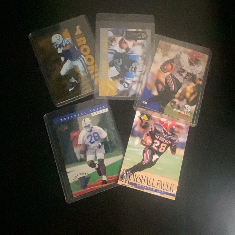 Marshall Faulk Football Cards Lot: A collection of five Marshall Faulk football trading cards. The cards feature various designs and team uniforms, including Indianapolis Colts imagery and San Diego State collegiate representation. Sev