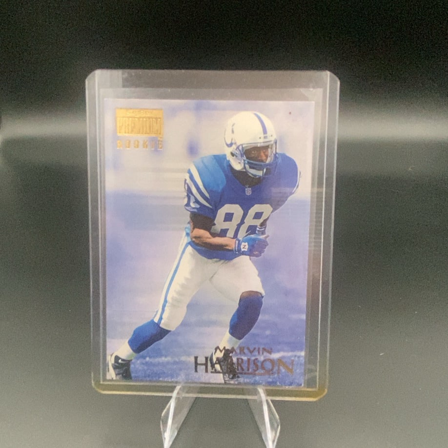 1996 SkyBox Premium Marvin Harrison: This is a 1996 SkyBox Premium rookie trading card featuring Indianapolis Colts wide receiver Marvin Harrison. The card features a clear photo of the athlete in his blue uniform and displays a 'Premium