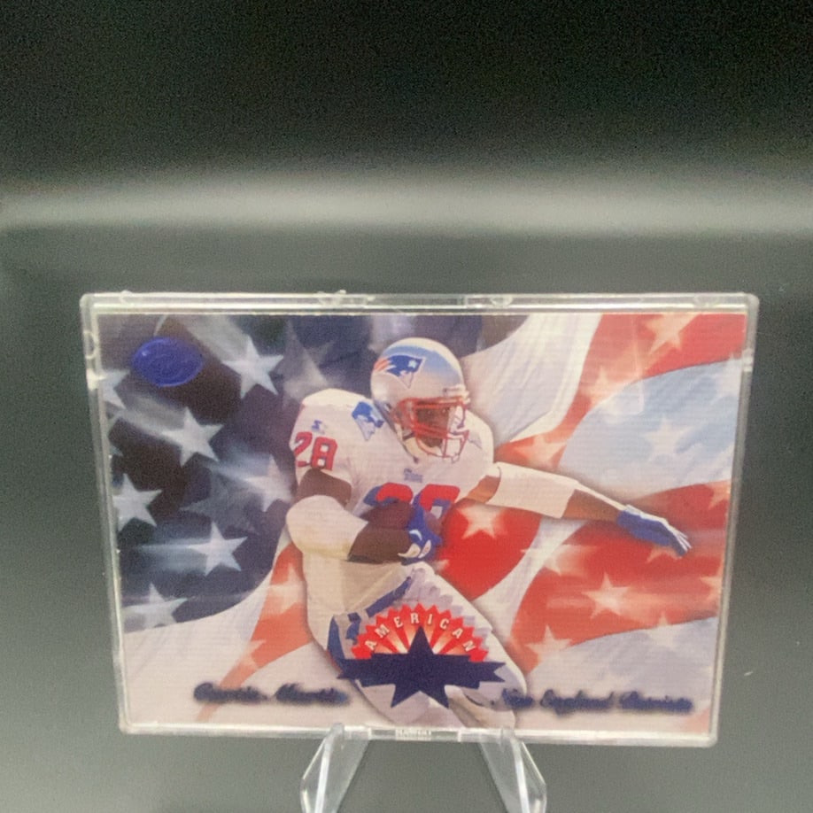 1997 Pacific American Curtis Martin: This is a 1997 Pacific football card featuring Curtis Martin of the New England Patriots. The card features a patriotic American flag background and is housed in a clear protective case.