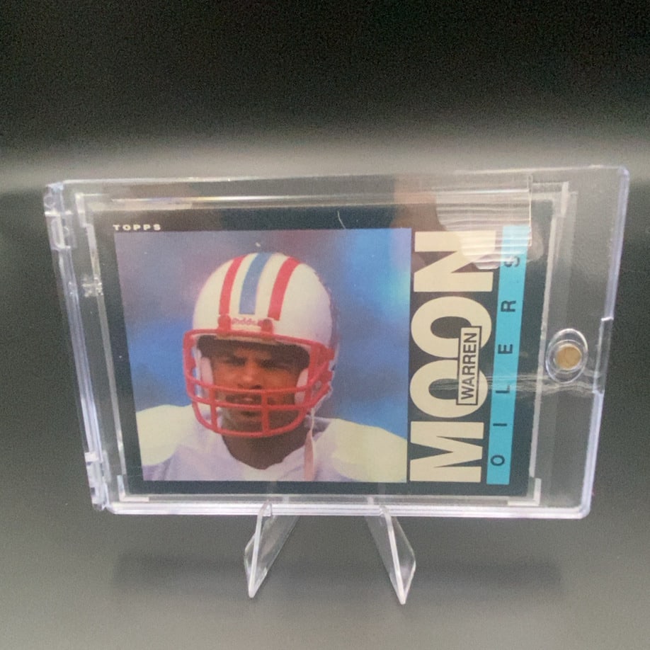 Topps Warren Moon Oilers: This is a vintage Topps trading card featuring Warren Moon of the Houston Oilers. The card displays a portrait of the player wearing his team helmet.