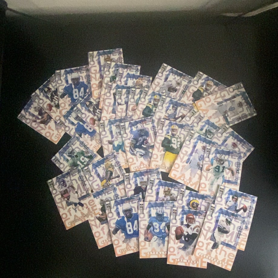 1999 Collector's Edge Odyssey Football Card Lot: This is a collection of various 1999 Collector's Edge Odyssey football cards featuring multiple players. Each card features the distinctive background text design of the 'Name of the Game' series. The