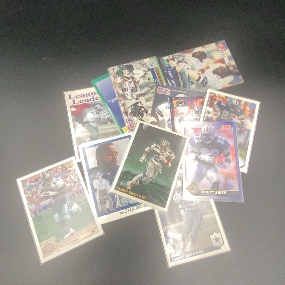 Emmitt Smith Football Card Collection: This lot features a collection of vintage football trading cards primarily focused on Dallas Cowboys running back Emmitt Smith. The cards represent various sets from the early 1990s, including Pro Set