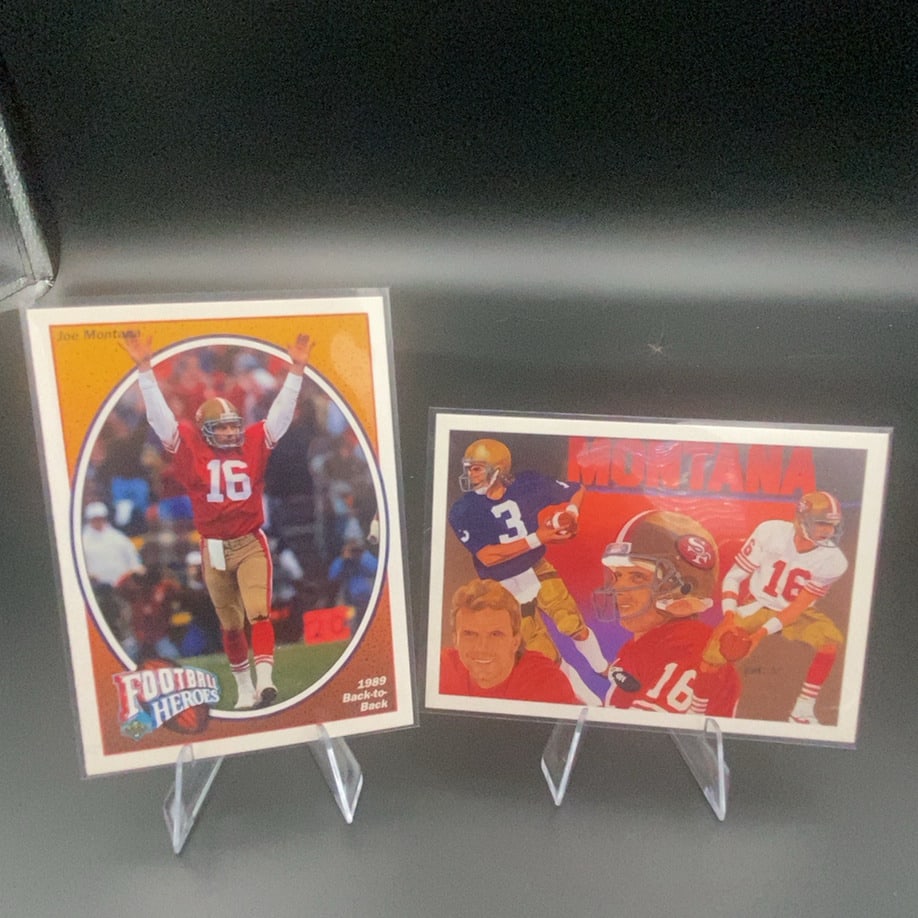 1989 Football Heroes Joe Montana: This lot features two Joe Montana football cards, including an 1989 Football Heroes card showcasing the San Francisco 49ers legend. The cards are displayed on plastic stands and feature action