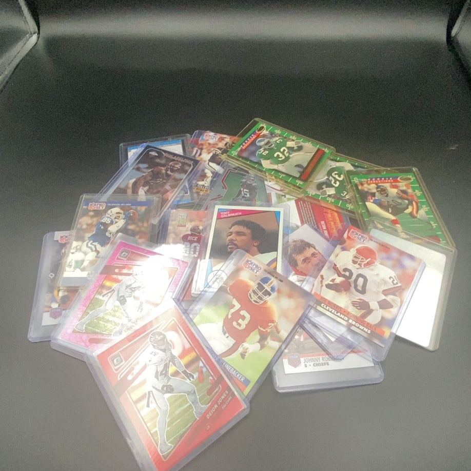 Mixed Collection of NFL Football Trading Cards: This is a collection of various vintage and modern NFL football trading cards, including multiple Pro Set editions and several Optic chrome-style cards. The lot features players such as Joe Morris of