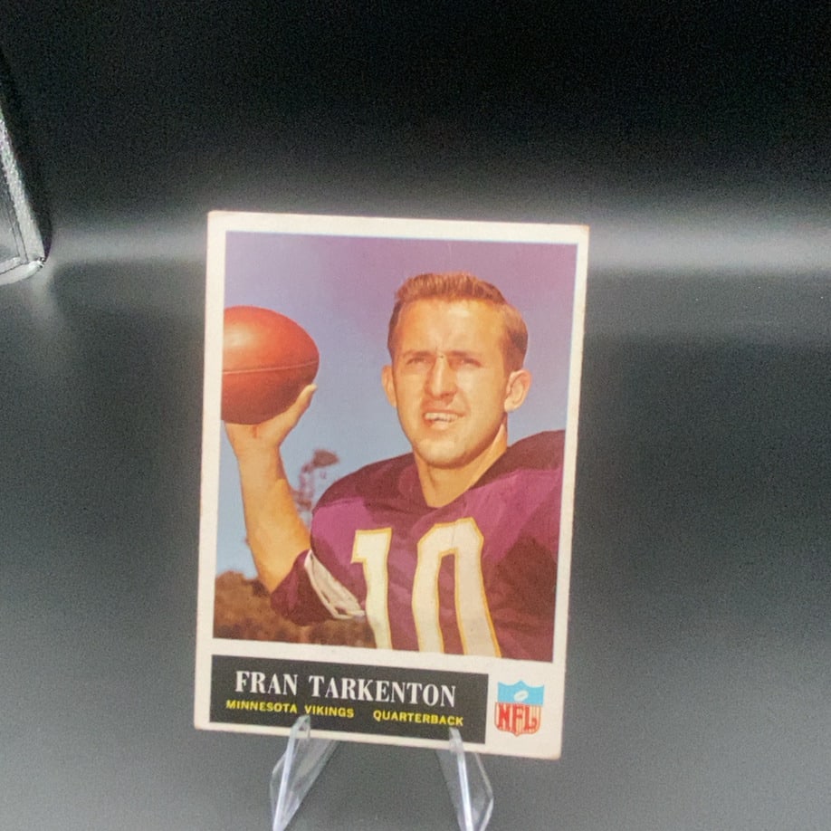 Fran Tarkenton Minnesota Vikings Quarterback: This is a vintage sports card featuring Fran Tarkenton, the quarterback for the Minnesota Vikings. The card displays a portrait of Tarkenton wearing his team jersey while holding a football. It also