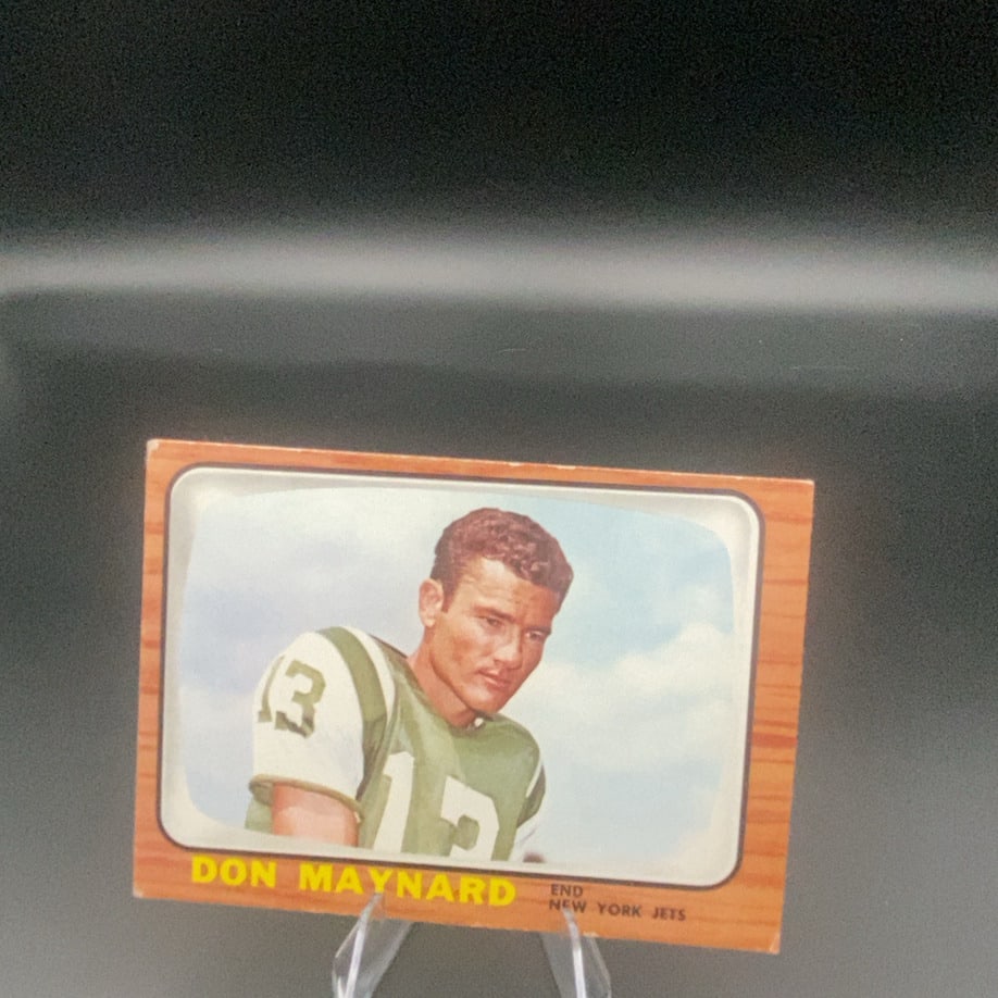 Don Maynard New York Jets: This is a vintage trading card featuring Don Maynard, an end for the New York Jets. The card displays a wood-grain border design and features a portrait of the player in his green and white uniform.