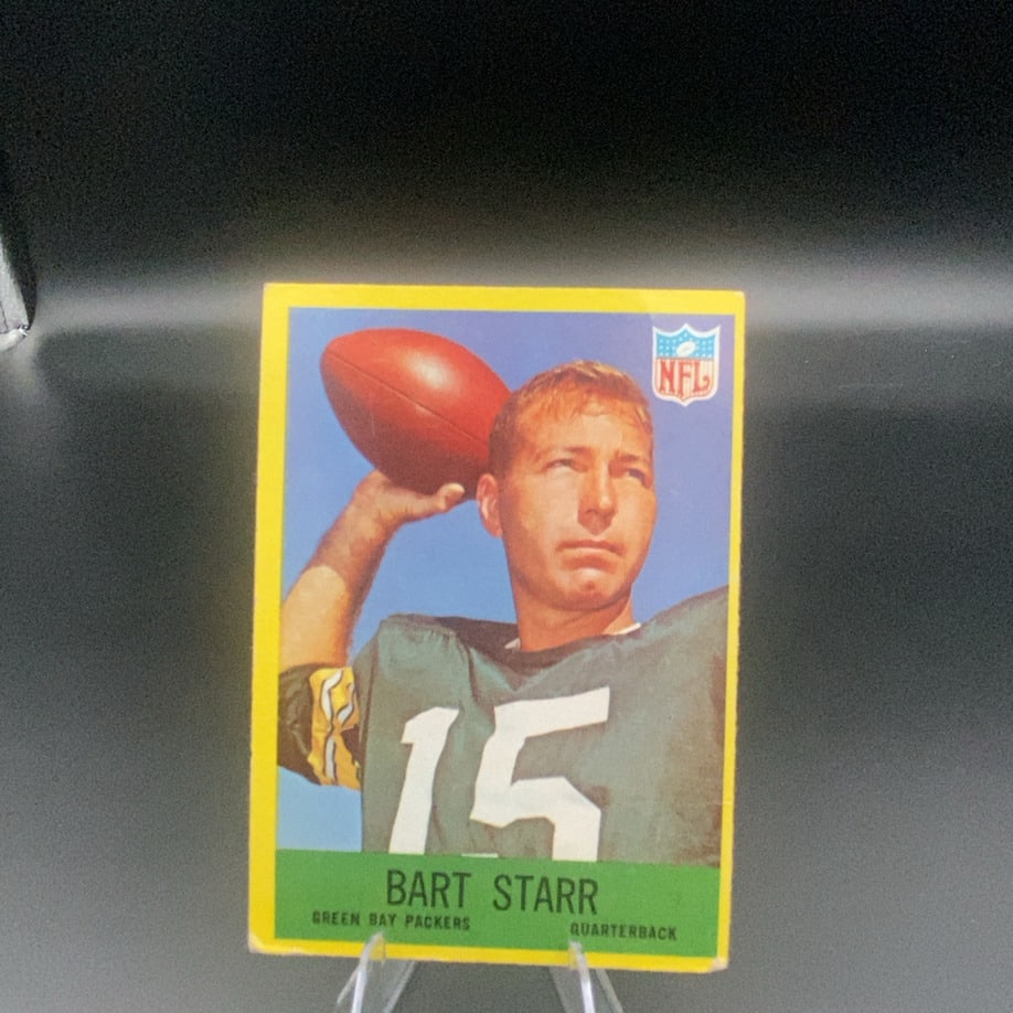 Bart Starr Green Bay Packers Football Card: This is a vintage football card featuring Bart Starr of the Green Bay Packers. The front displays the player in his jersey with the NFL logo in the upper right corner.