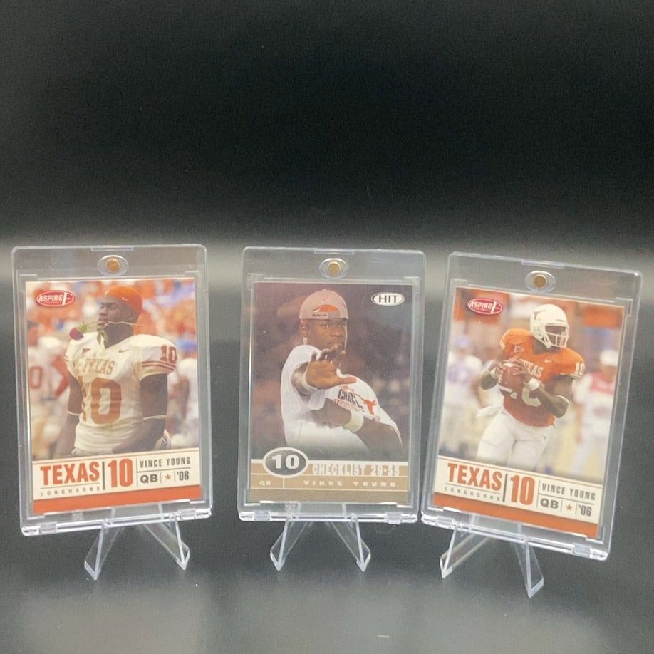 2006 Aspire and Hit Vince Young Cards: This image features three football trading cards showcasing Vince Young of the Texas Longhorns. It includes two cards from the Aspire brand and one card from the Hit set, all dated 2006. The cards