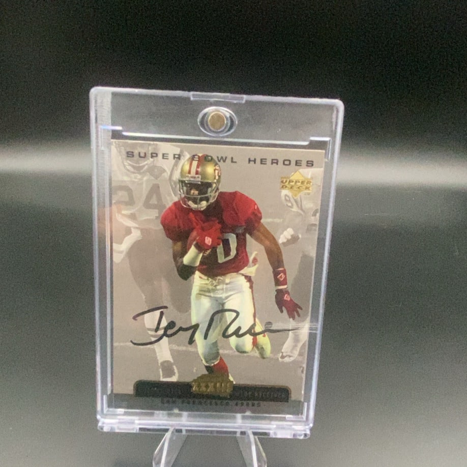 Upper Deck Super Bowl Heroes Jerry Rice: This is a collectible trading card featuring Jerry Rice of the San Francisco 49ers from the Upper Deck Super Bowl Heroes series. The card features an action shot of the wide receiver and a printed sig