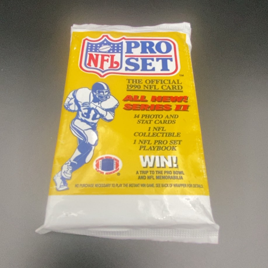 1990 Pro Set Series II NFL Card Pack: This is a sealed 1990 Pro Set Series II NFL trading card pack. The wrapper features iconic branding and mentions it includes 14 photo and stat cards along with a collectible and playbook. It is a