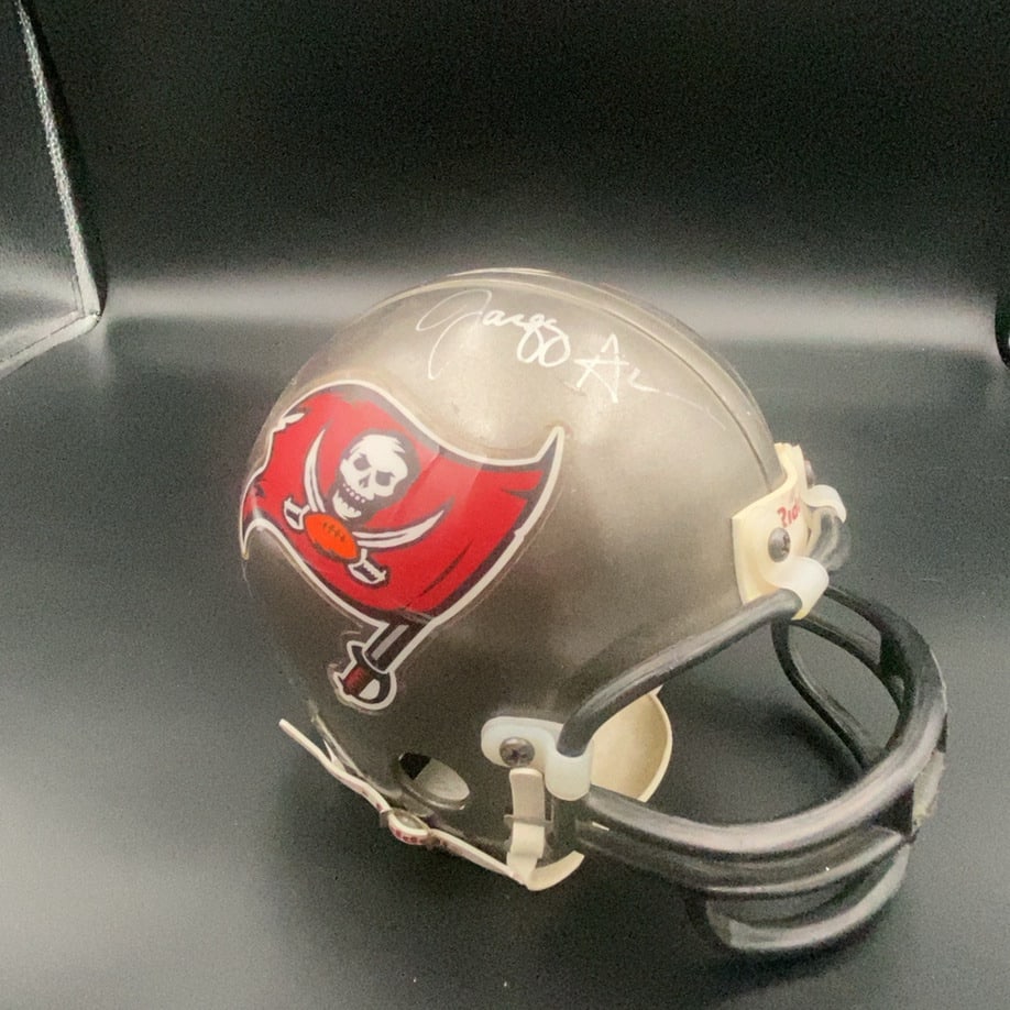 Tampa Bay Buccaneers Mini Helmet: This is a collectible Tampa Bay Buccaneers mini football helmet. It features the team logo on the side and a signature on the top.