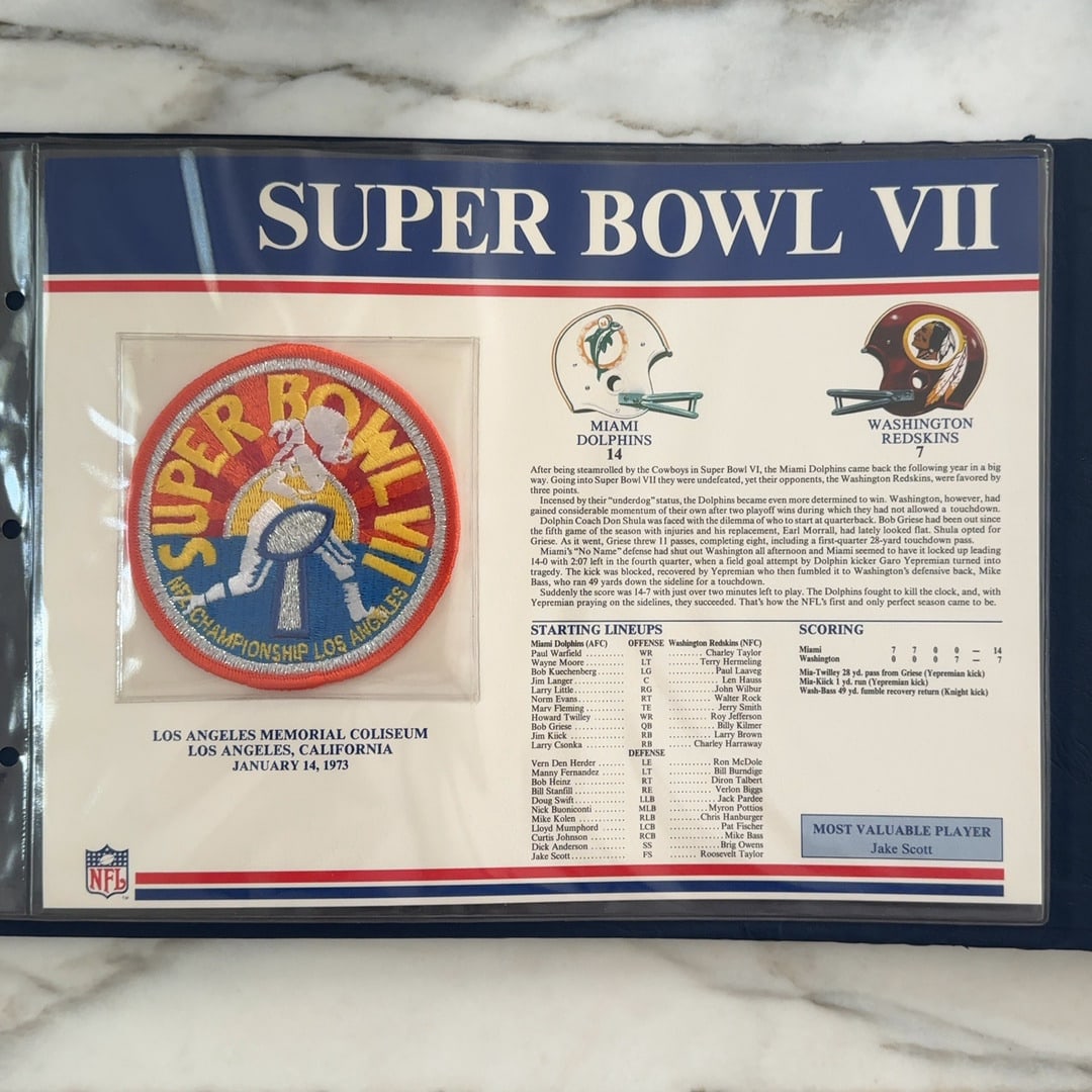 1973 NFL Super Bowl VII Commemorative Display: This is a Super Bowl VII commemorative collectible featuring an embroidered patch from the 1973 game held at the Los Angeles Memorial Coliseum. The display provides detailed game information, includin