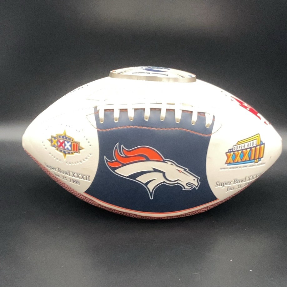 Denver Broncos Super Bowl Commemorative Foo: a commemorative football featuring the Denver Broncos team logo. The ball displays markings for both Super Bowl XXXII, played on January 25, 1998, and Super Bowl XXXIII, played on January 31, 1999.