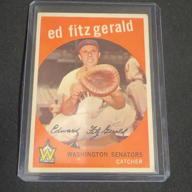 1959 Vintage Topps Ed Fitz Gerald Washington Senators: 1959 Vintage Topps baseball card featuring Ed Fitz Gerald of the Washington Senators. The card is encased in a protective plastic top loader. It highlights his position as a catcher and includes a