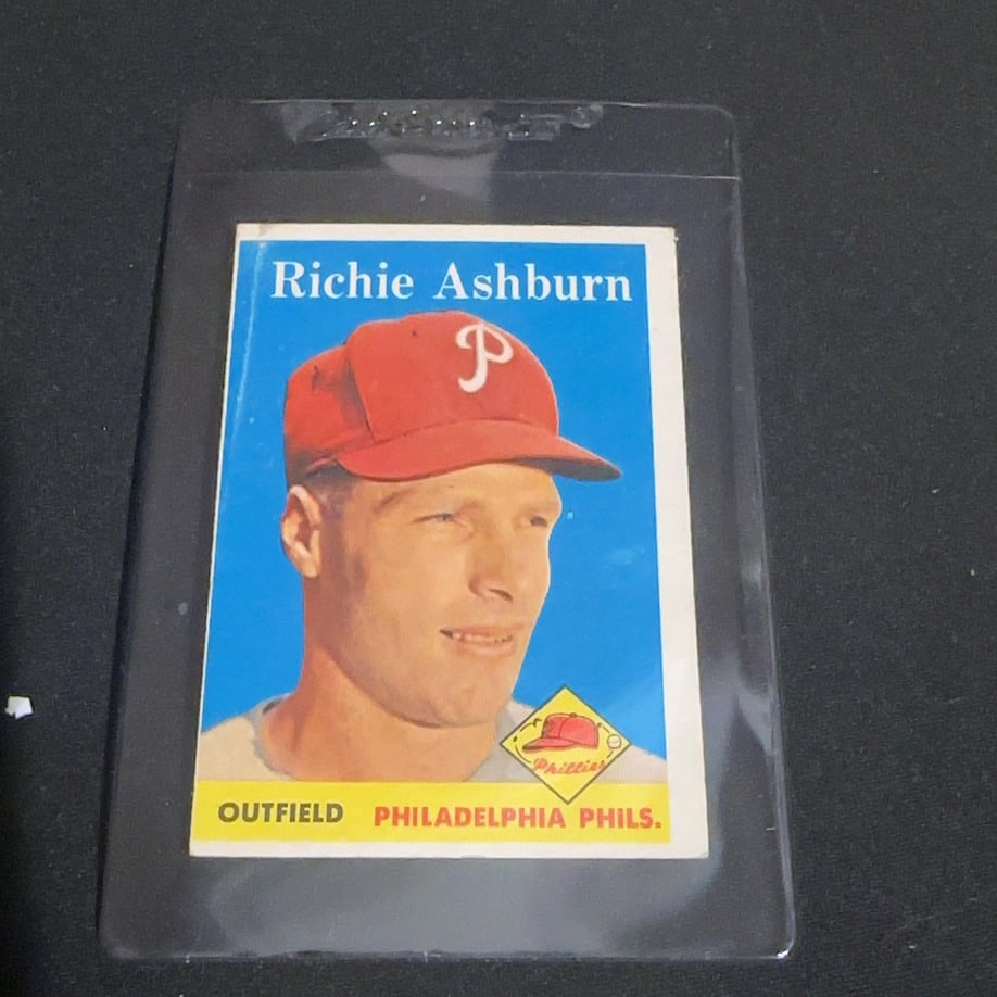 1958 Vintage Topps Richie Ashburn Baseball Card: This is a 1958 Vintage Topps baseball card featuring Philadelphia Phillies outfielder Richie Ashburn. The card displays a portrait of the athlete wearing his red Phillies cap with a small emblem in th