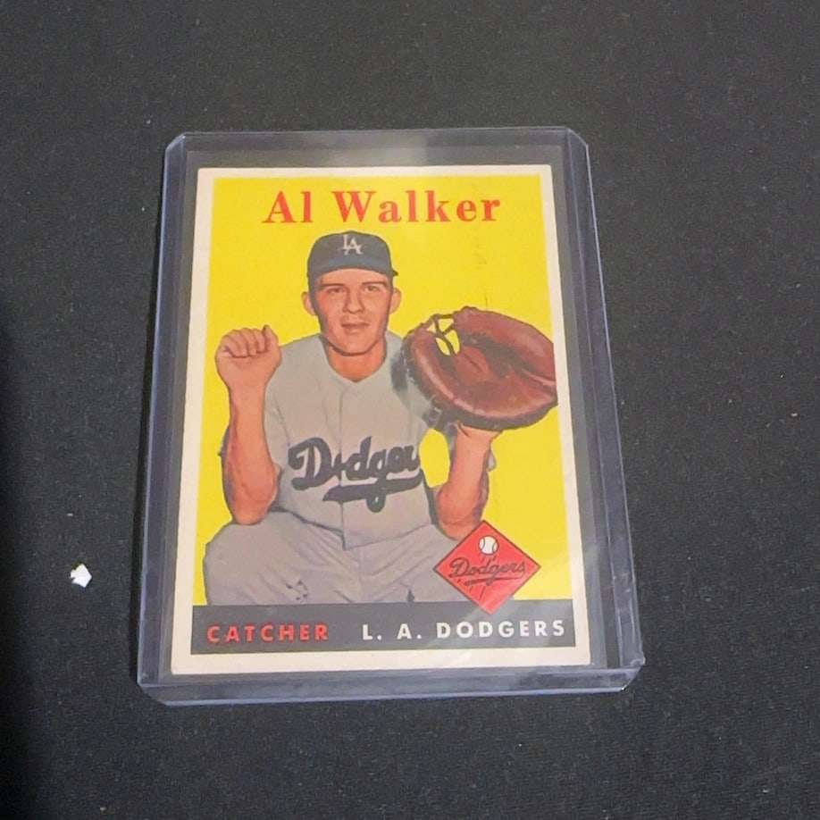 1958 Vintage Topps Al Walker Dodgers Baseball Card: This is a 1958 Vintage Topps baseball card featuring Al Walker of the Los Angeles Dodgers. The card depicts the catcher in his uniform with a yellow background and a prominent Dodgers team logo. It