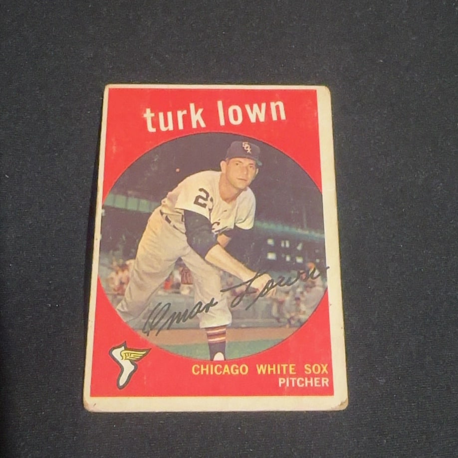 1959 Vintage Topps Turk Lown: 1959 Vintage Topps baseball card featuring Chicago White Sox pitcher Turk Lown. The card displays a player portrait within a circular frame on a red background and includes a printed signature and