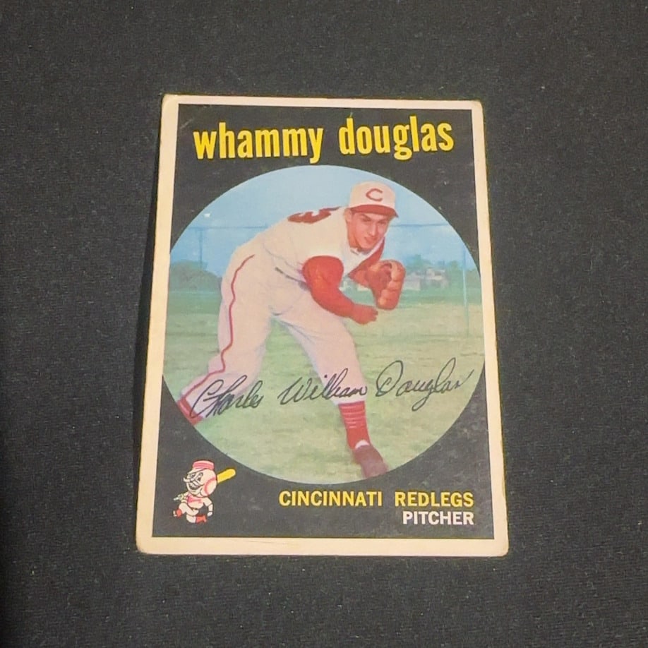 1959 Vintage Whammy Douglas Cincinnati Redlegs Sports Card: 1959 Vintage sports card featuring Whammy Douglas of the Cincinnati Redlegs. The card identifies him as a pitcher and includes a facsimile autograph across the player image. A small cartoon mascot of
