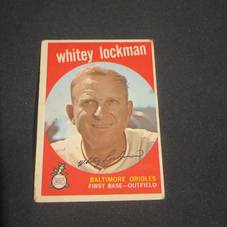 1959 Vintage Topps Whitey Lockman Baltimore Orioles Baseball Card: 1959 Vintage Topps baseball card featuring Whitey Lockman of the Baltimore Orioles. The card is in vintage condition with visible wear, particularly on the edges and corners, and exhibits the classic 