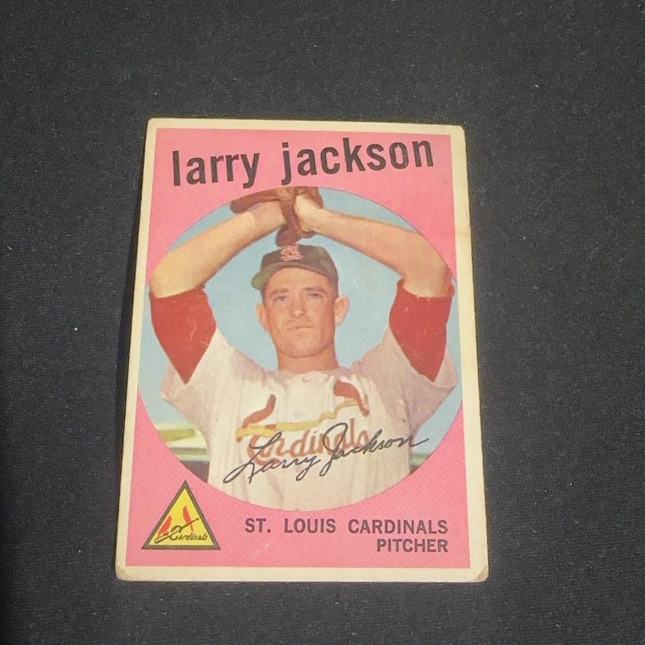 1959 Vintage Larry Jackson St. Louis Cardinals Baseball Card: 1959 Vintage baseball card featuring Larry Jackson, a pitcher for the St. Louis Cardinals. The card features a portrait of the player and his printed signature, with the Cardinals team logo in the cor