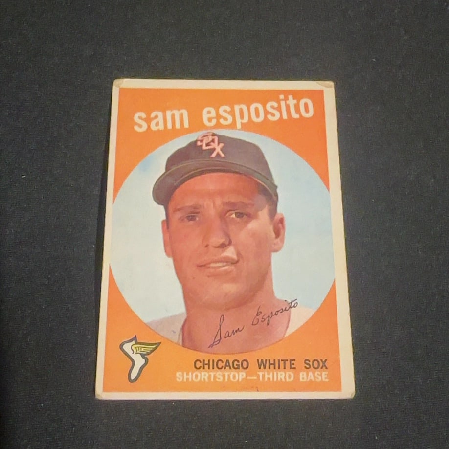 1959 Vintage Sam Esposito Chicago White Sox Baseball Card: 1959 Vintage baseball card featuring Sam Esposito of the Chicago White Sox. The card lists his positions as shortstop and third base and features a portrait of the player. It has a distinctive orange
