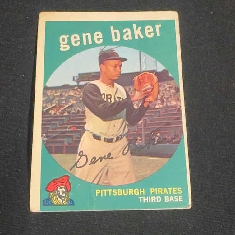 1959 Vintage Topps Gene Baker: 1959 Vintage Topps baseball card featuring Gene Baker of the Pittsburgh Pirates. The card shows Baker in his Pirates uniform and identifies him as a third baseman, including a facsimile signature and