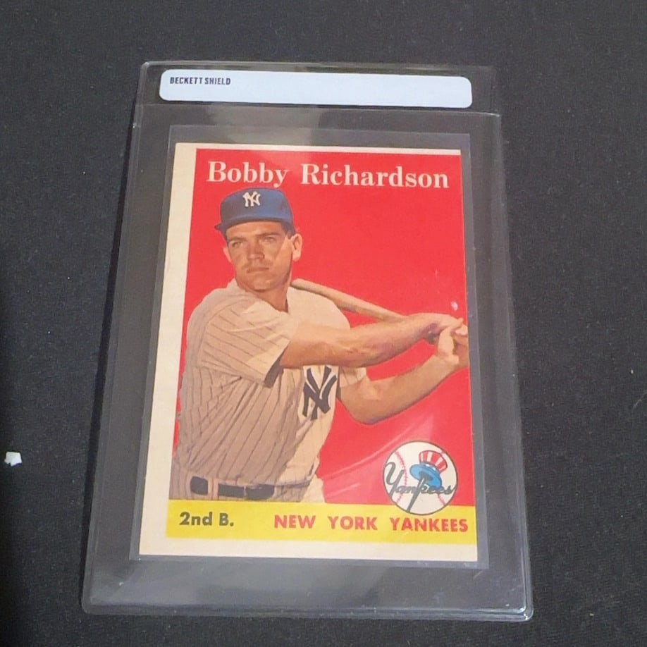 Bobby Richardson New York Yankees Baseball Card: This is a vintage trading card featuring New York Yankees second baseman Bobby Richardson. The card is professionally encased in a Beckett Shield protective holder. It displays the player's name at th