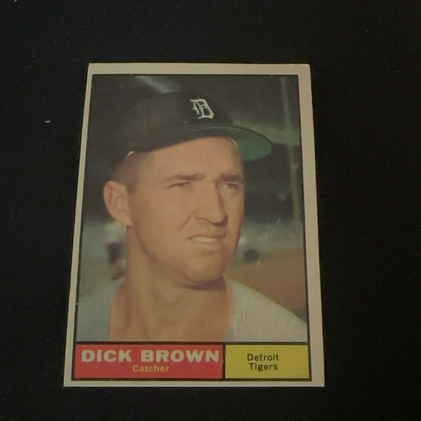 1961 Topps Dick Brown: 1961 Topps baseball card featuring Dick Brown, who is identified as a catcher for the Detroit Tigers. The card features a portrait of the player and displays his name, position, and team on the front.