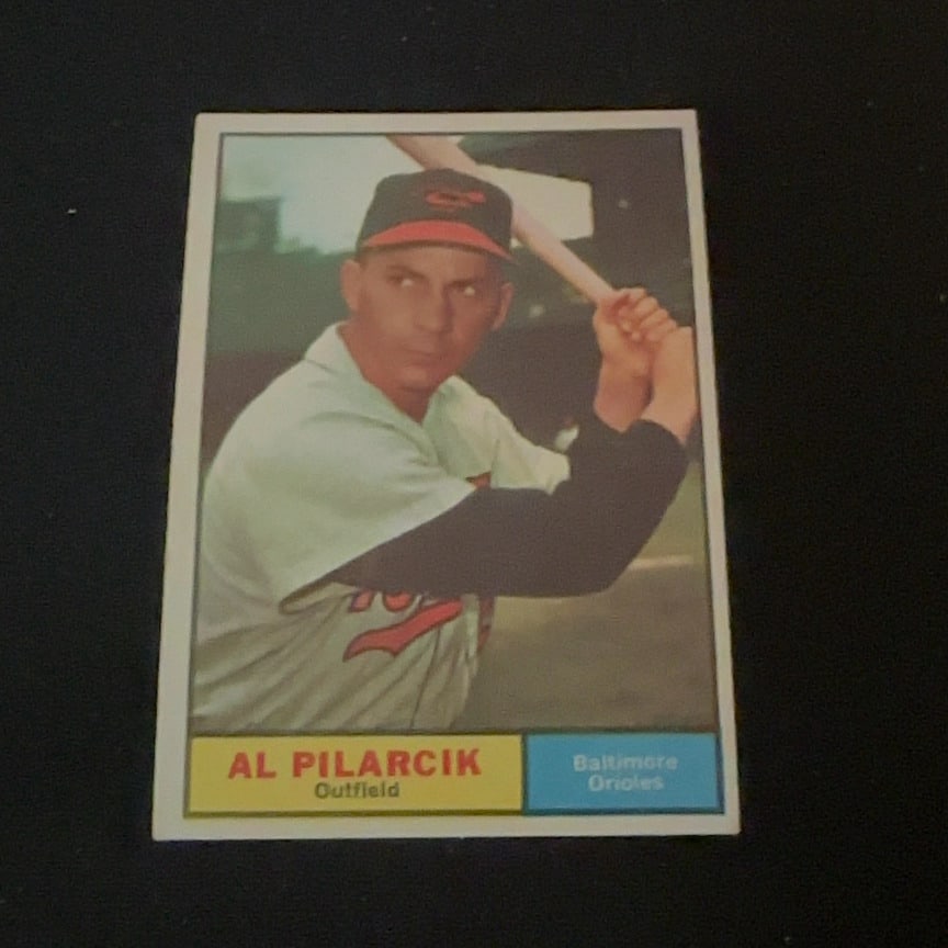 Al Pilarcik Baltimore Orioles: This is a vintage baseball trading card featuring Al Pilarcik of the Baltimore Orioles. The card identifies his position as Outfield. The design features a color photograph of the player at the plate.