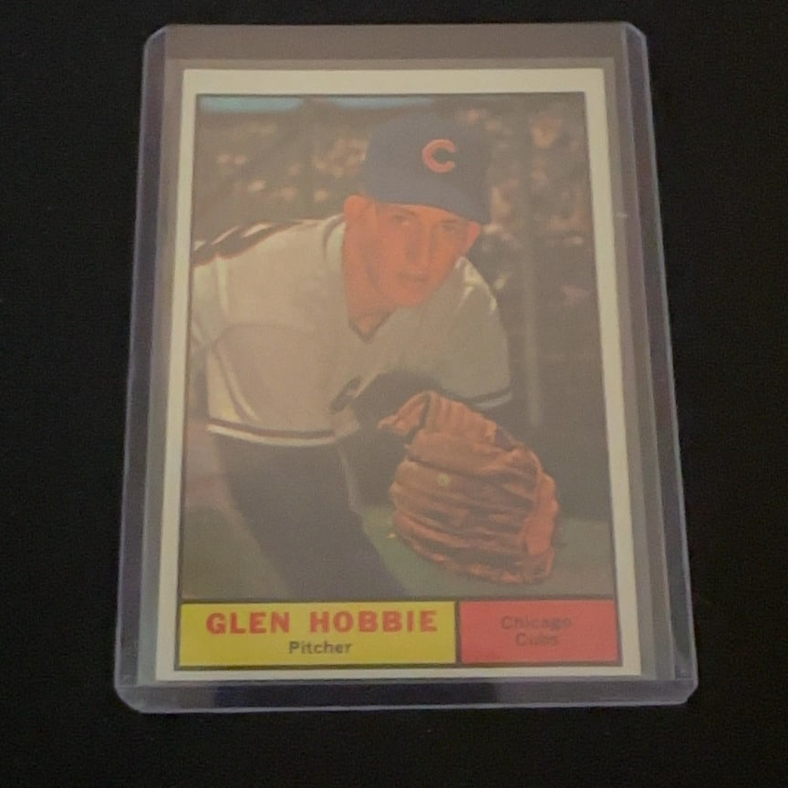 1961 Topps Glen Hobbie: 1961 Topps baseball card featuring Chicago Cubs pitcher Glen Hobbie. The card showcases a classic portrait style image of the player in his Cubs uniform. It is a vintage sports collectible from the 19