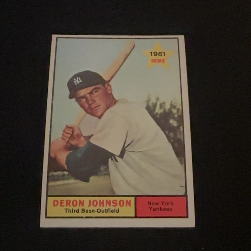 1961 Topps Deron Johnson: This is a 1961 Topps baseball card featuring New York Yankees player Deron Johnson. The card features a '1961 Rookie' star emblem in the upper right corner and identifies him as a Third Base-Outfield 