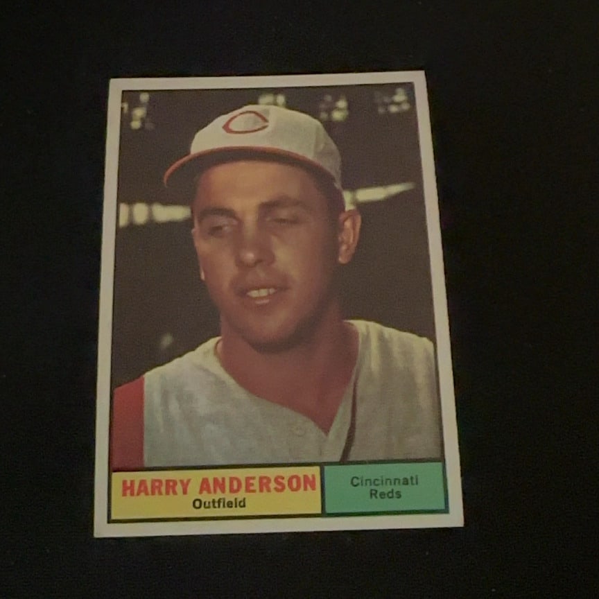 Harry Anderson Cincinnati Reds: This is a vintage baseball card featuring Harry Anderson of the Cincinnati Reds. The card identifies him as an outfielder and shows him in his team uniform. The design features a portrait-style