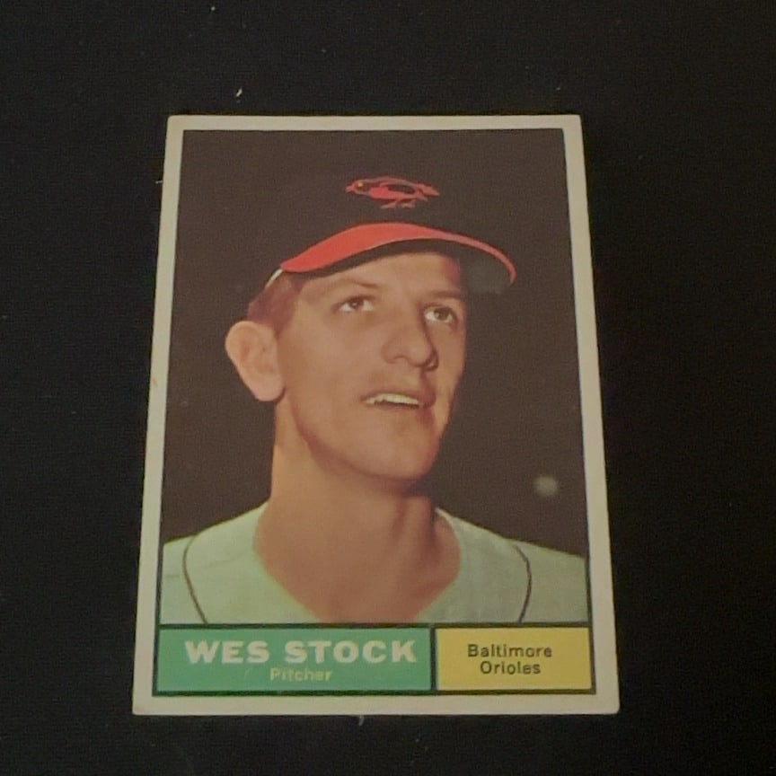 Wes Stock Baltimore Orioles: This is a vintage baseball card featuring Wes Stock, a pitcher for the Baltimore Orioles. The front of the card displays his portrait, name, position, and team affiliation. It is a classic sports