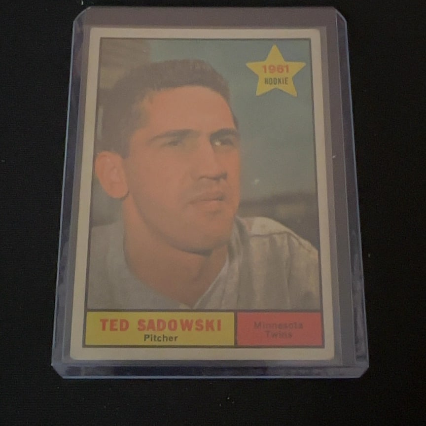 1961 Topps Ted Sadowski Rookie Card: This is a 1961 Topps baseball card featuring Minnesota Twins pitcher Ted Sadowski. The card is marked as a rookie card and is housed in a clear protective plastic sleeve.