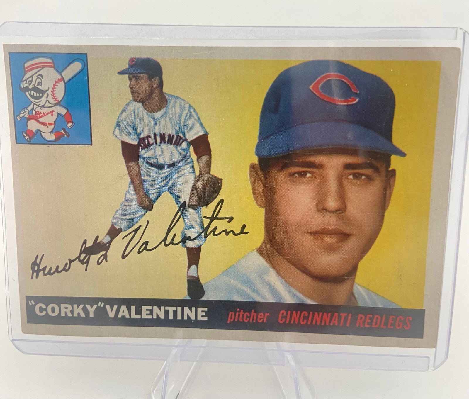 1955 Topps Corky Valentine Baseball Card: 1955 Topps baseball card featuring Cincinnati Redlegs pitcher Harold "Corky" Valentine. The card exhibits a classic design with a dual-image layout, a facsimile autograph, and the iconic Mr. Redlegs