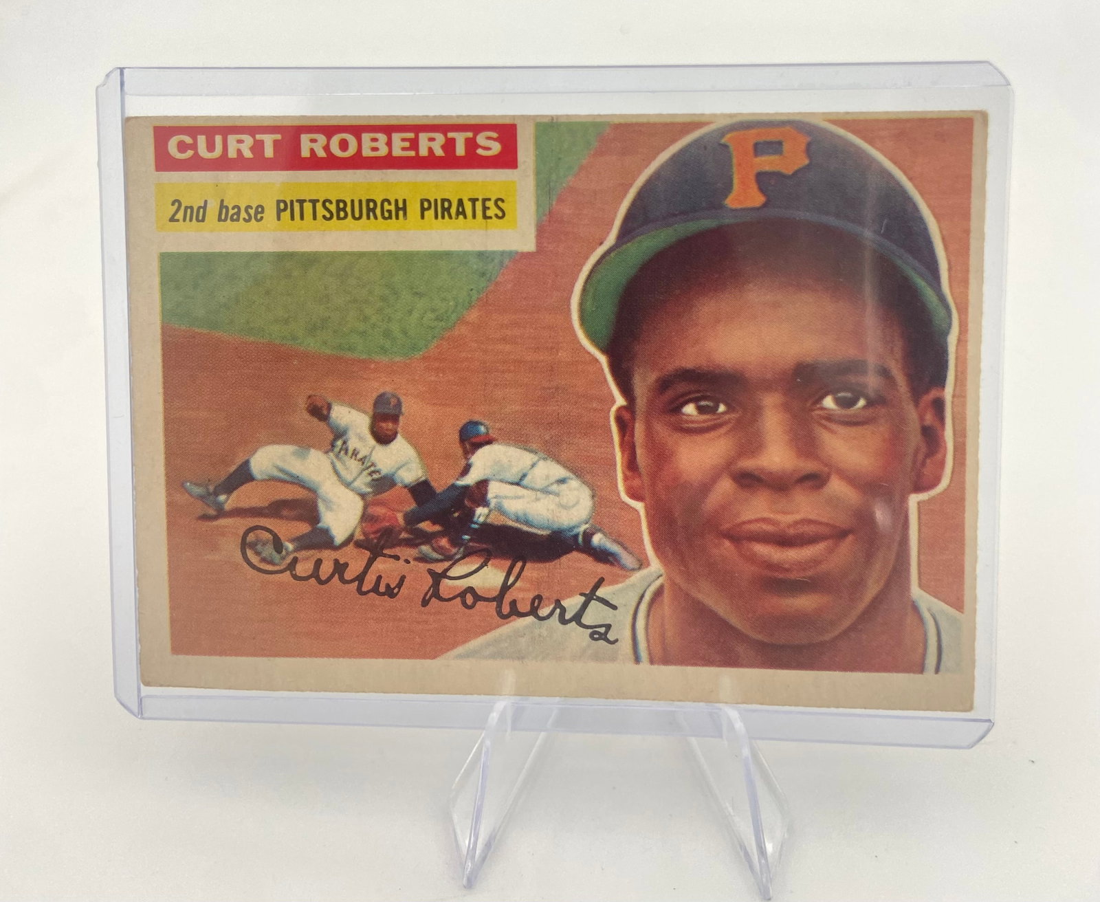 1956 Topps Curt Roberts Baseball Card: This is a 1956 Topps baseball card featuring Pittsburgh Pirates second baseman Curt Roberts. The card displays a portrait of Roberts alongside an action shot of him playing in the field, with a