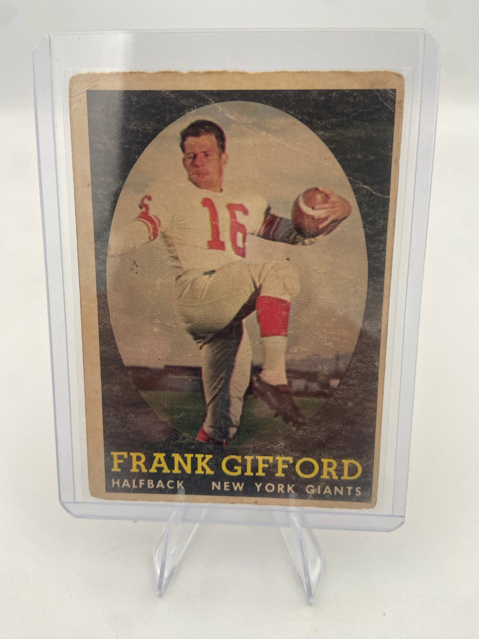 1958 Topps Frank Gifford New York Giants Football Card: 1958 Topps football card featuring Hall of Fame halfback Frank Gifford of the New York Giants. The card shows signs of significant wear, including heavy surface creasing, edge rounding, and visible